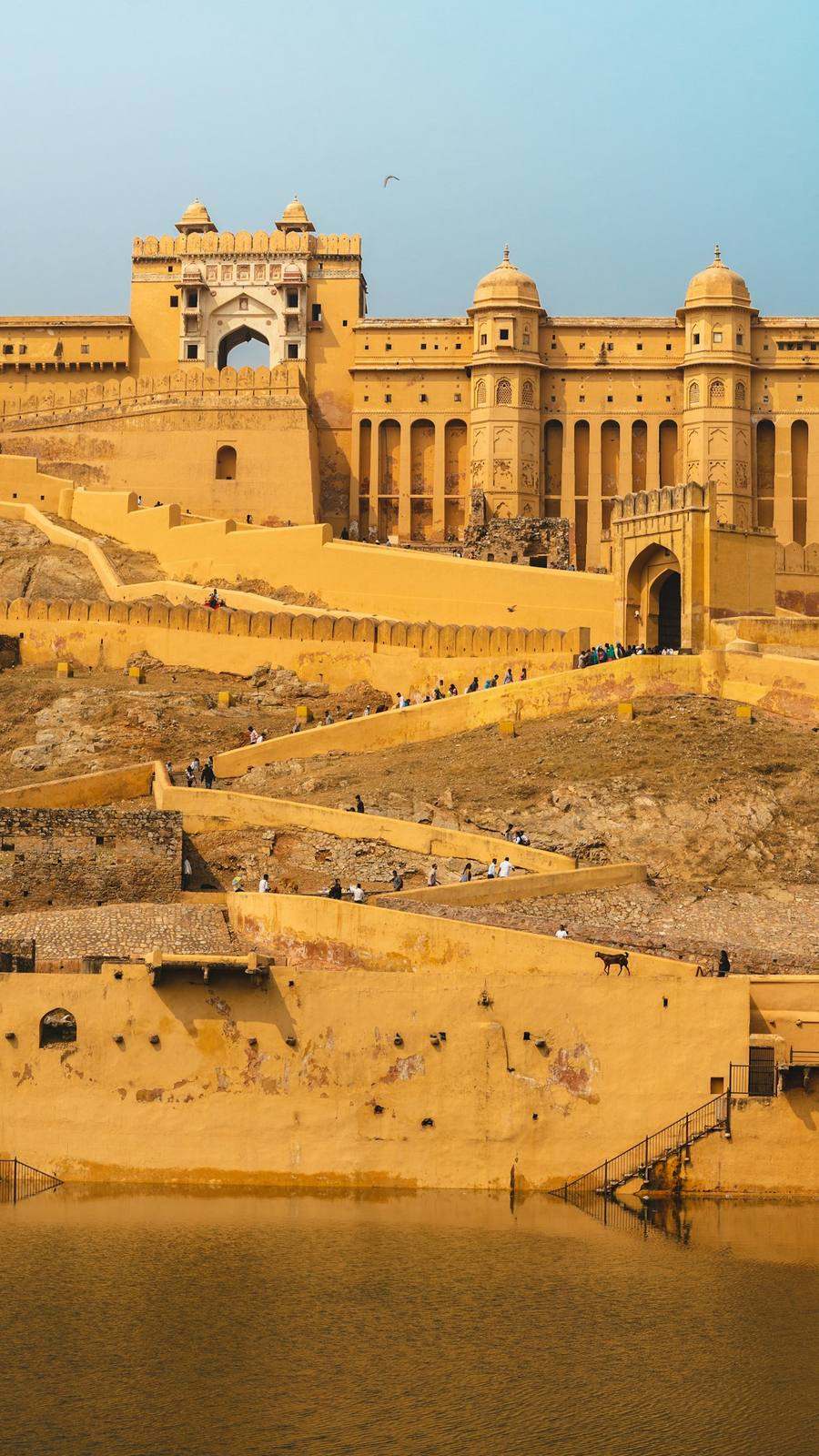 Amber Fort in honey-coloured sandstone rising above the water, Amer, Jaipur